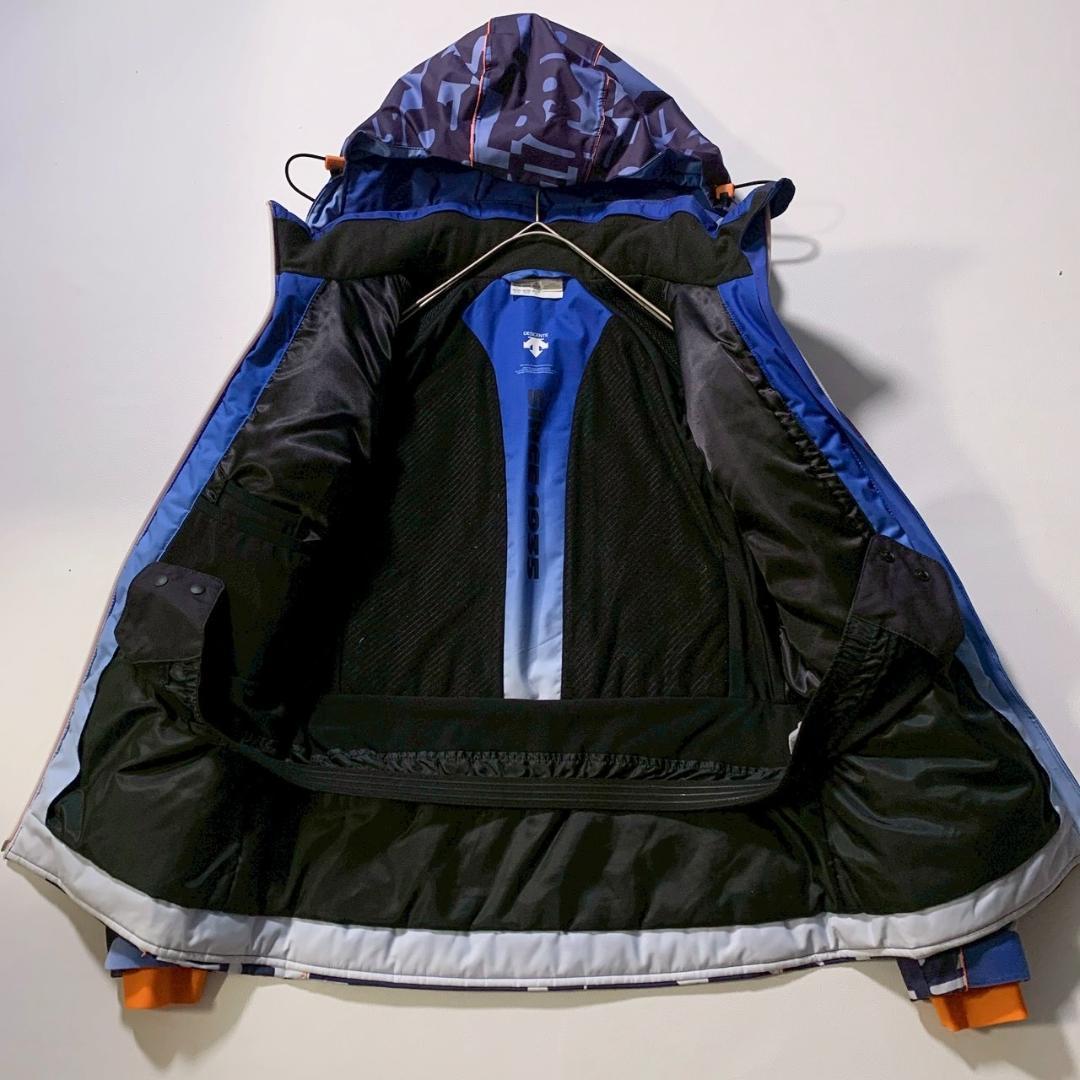 【高機能】デサント スキージャケット モーション3D ヒートナビ 総柄 青 M