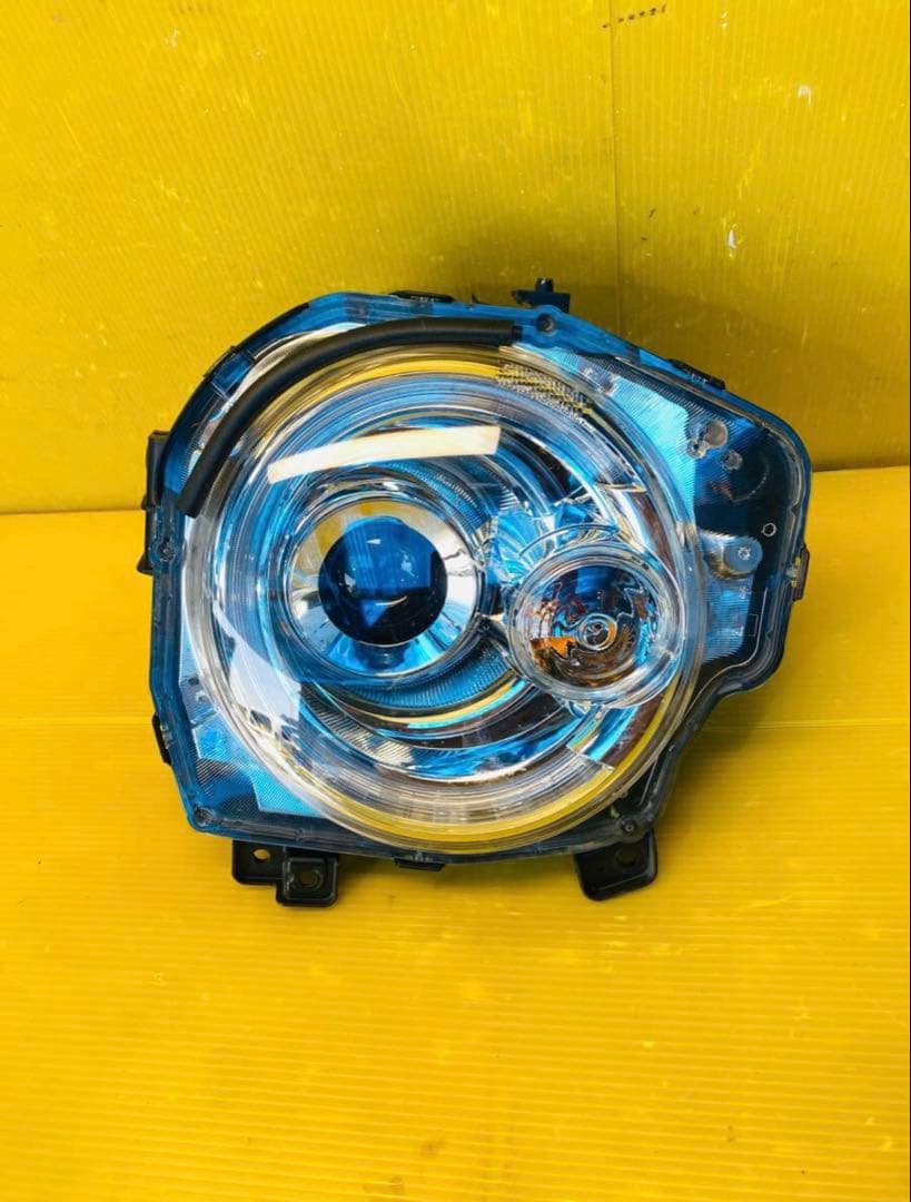 スズキラパンHE33S 左ヘッドライトICHIKOHA021