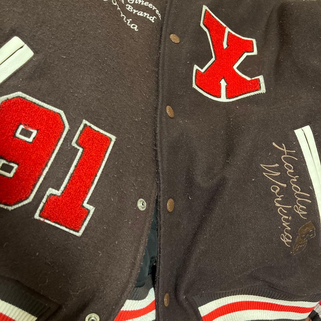 XLARGE ダークブラウン スタジャン Ｍ 袖に汚れあり　毛玉あり