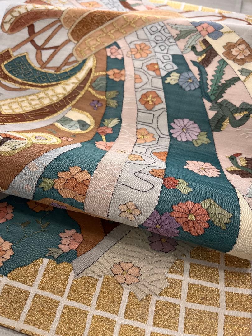 仕立て上がり新品袋帯　薄いグレーに鶴松花宝尽くしなどおめでたい柄　とても可愛い