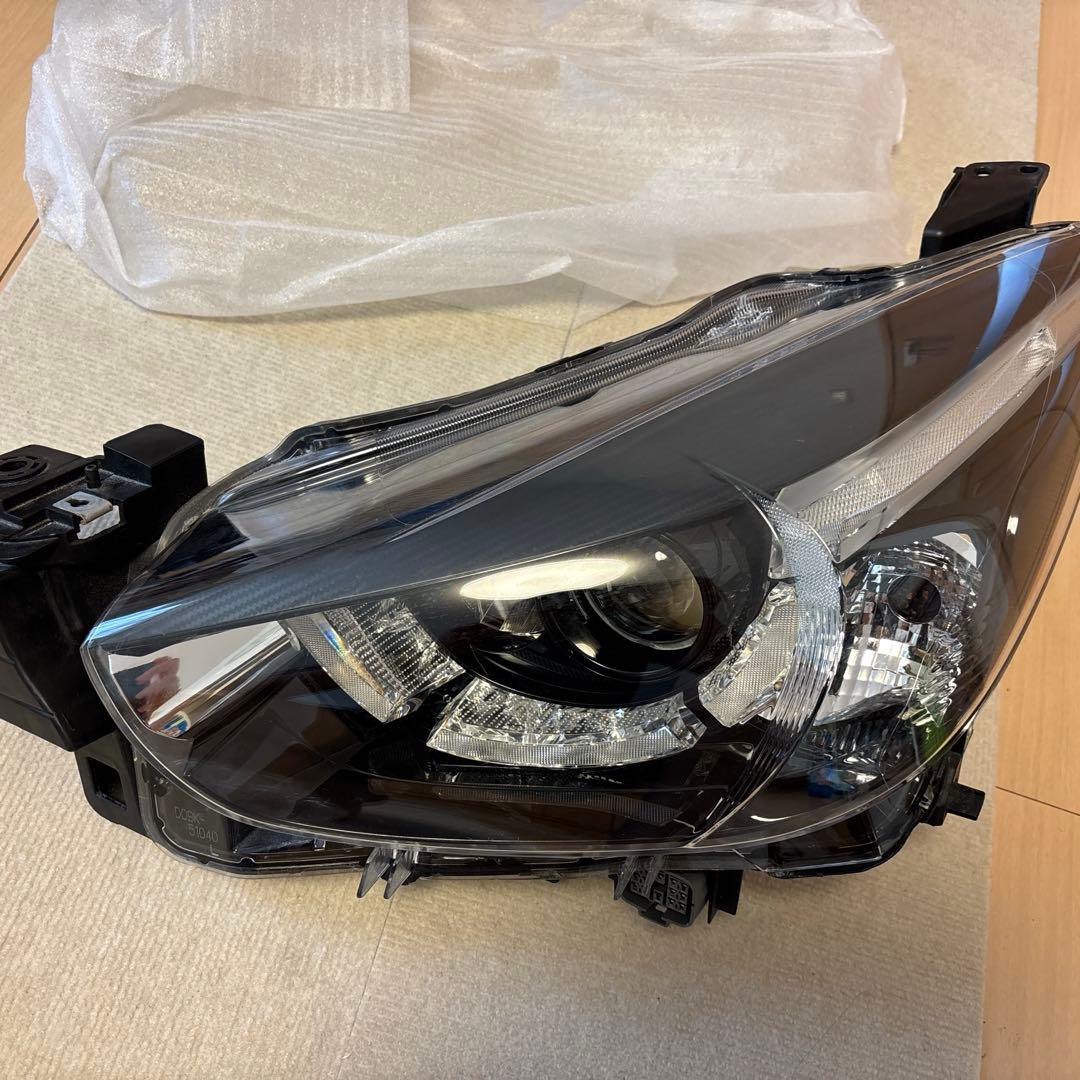 DJデミオ　左ヘッドランプ