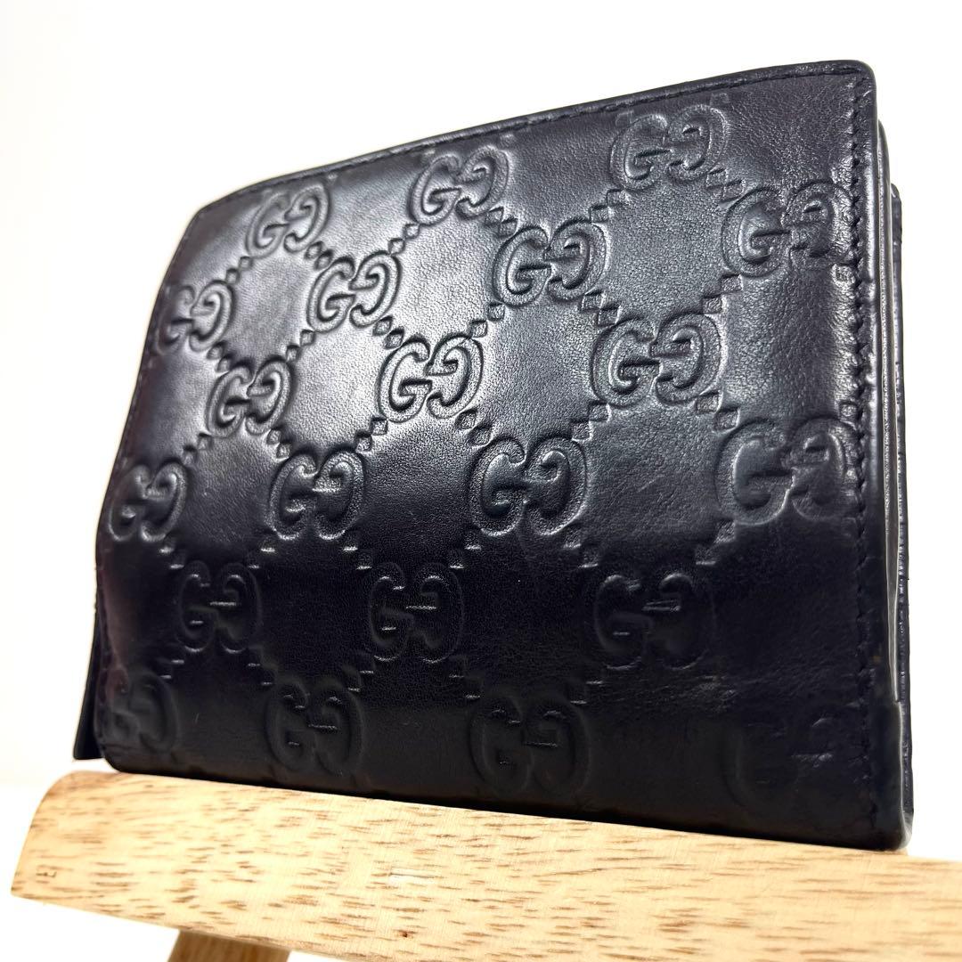 グッチ　二つ折り財布　アビー　シマレザー　ラウンドファスナー　ロゴ　エンボス