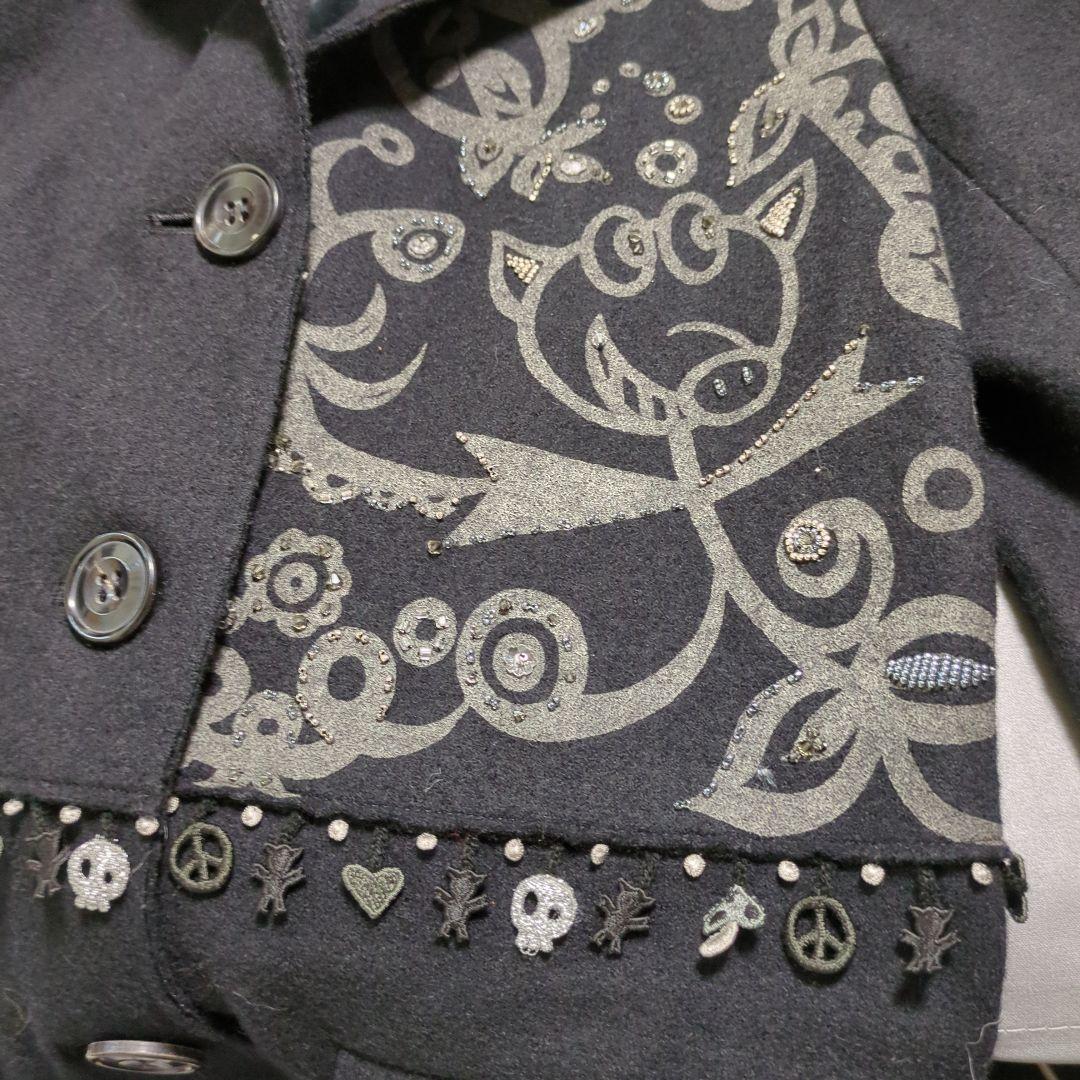 黒い装飾付きチェスターコート、白のファー付きベスト