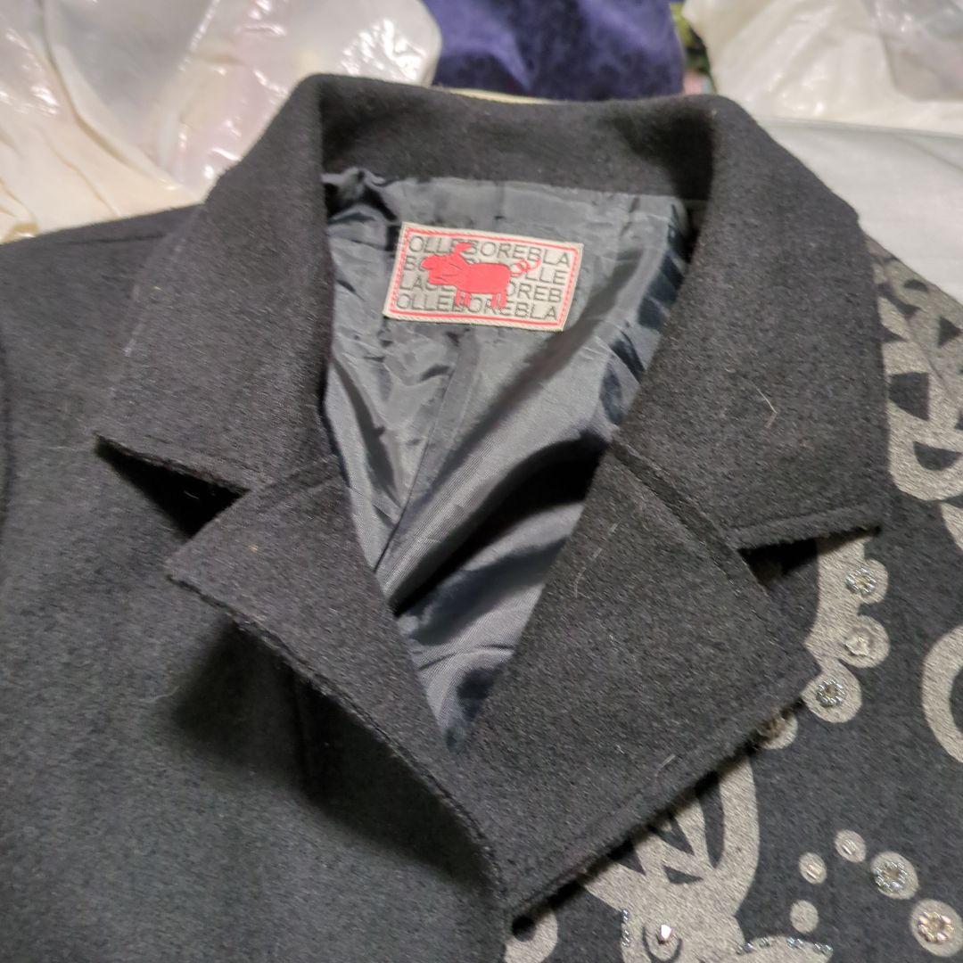 黒い装飾付きチェスターコート、白のファー付きベスト