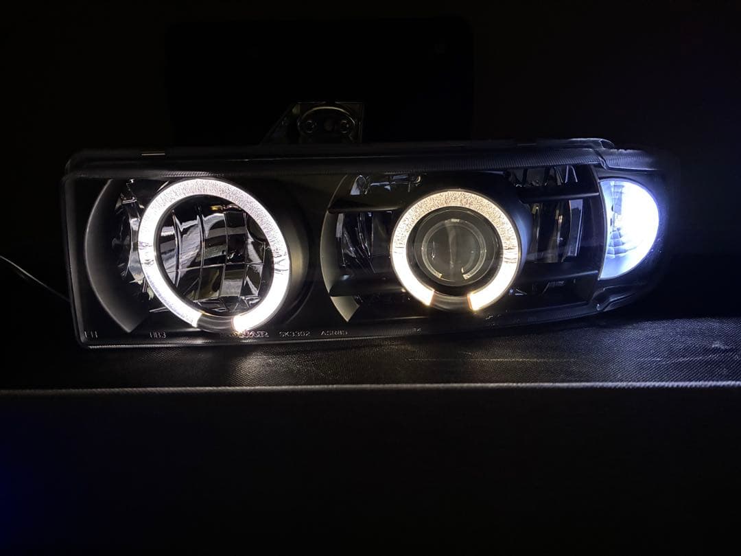 シボレーアストロGMCサファリ用ヘッドライトイカリング付左右セット 社外品