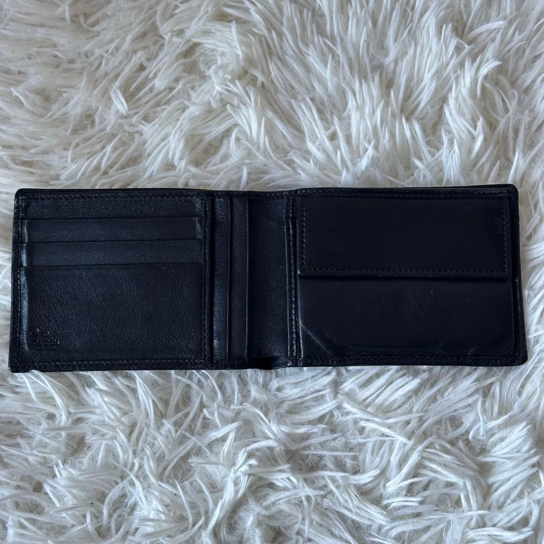 グッチ GGシマ 二つ折り財布 型押し レザー コンパクト 黒 総柄 エンボス