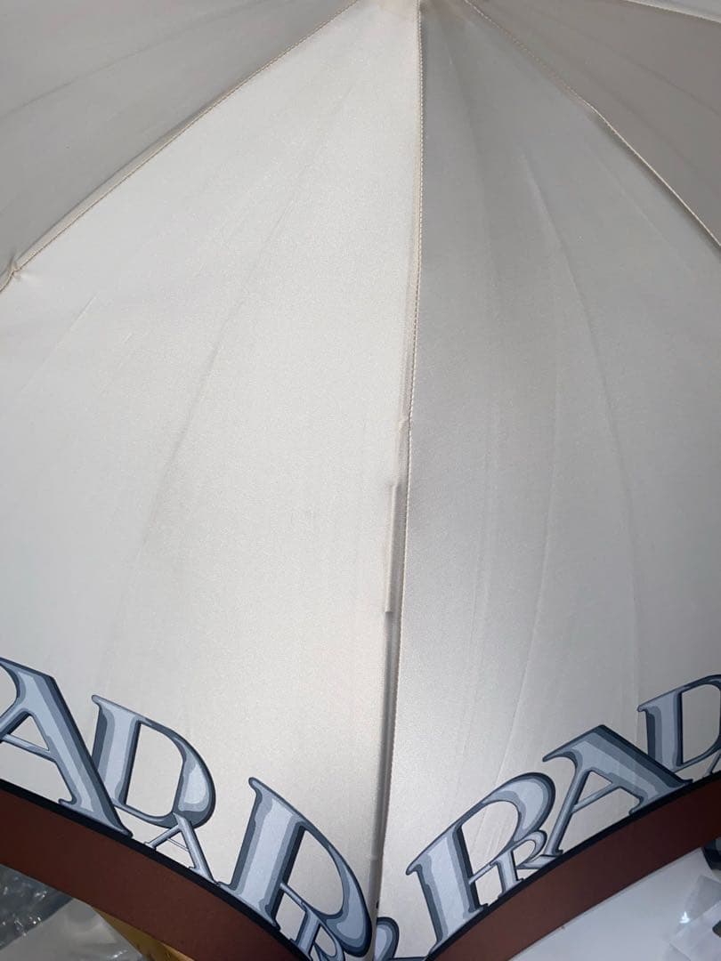 PRADA 長傘 ホワイト系・ブラウンLOGOプリント柄長さ92com