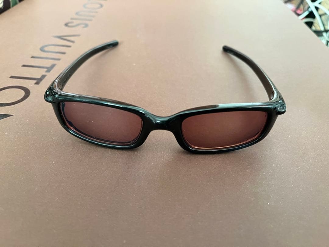 Oakley スポーツサングラス 黒 オレンジの度付きレンズ