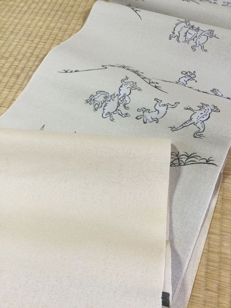素敵な装い！西陣名古屋帯 綿芯手縫い仕立、ガード加工付 「鳥獣人物戯画」クリーム