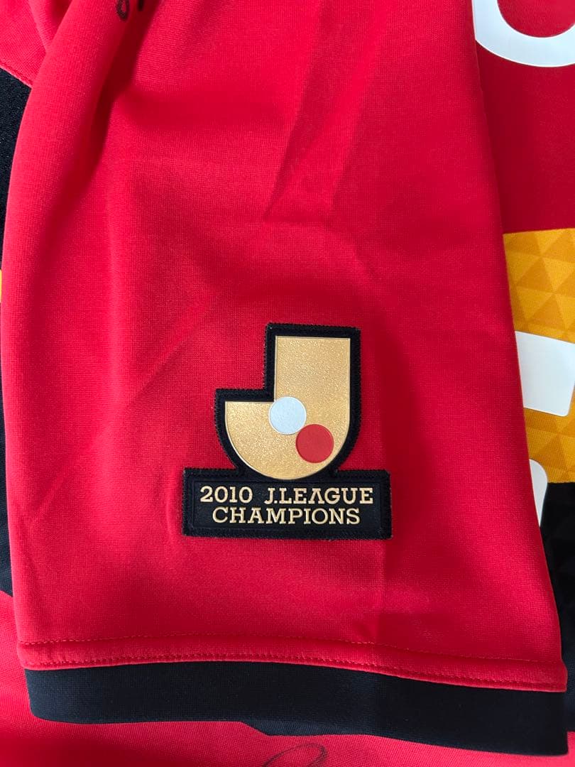 名古屋グランパス 2011 金崎夢生 優勝ロゴ（当時在籍選手サイン入）Ｏサイズ