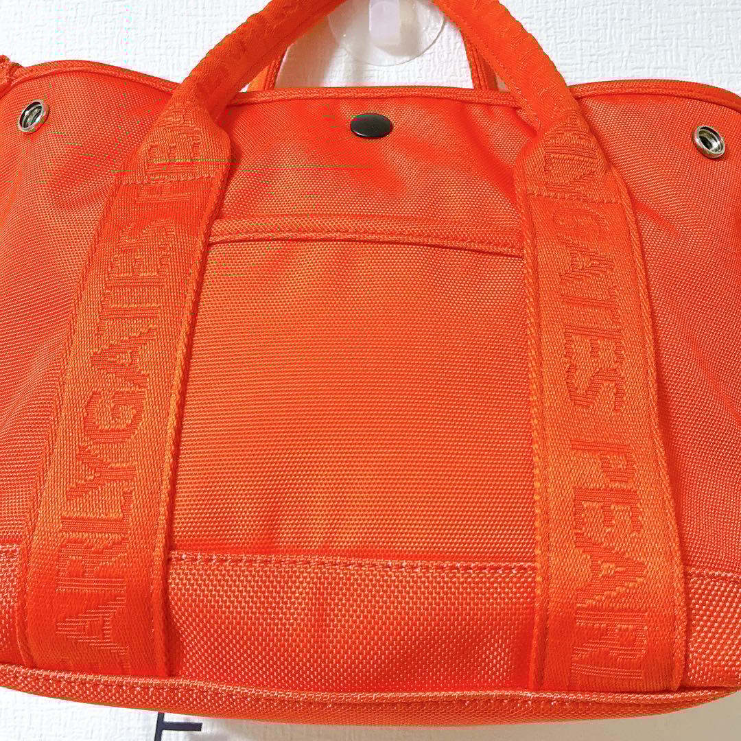 極美品 パーリーゲイツ ゴルフバッグ オレンジ ロゴチャーム付きカートバッグ