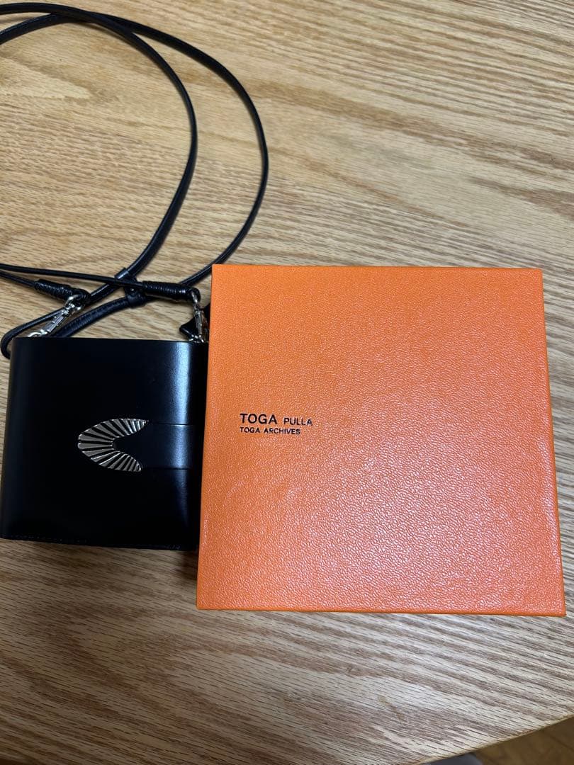 ブラックのレザー製二つ折り財布TOGA PULLA