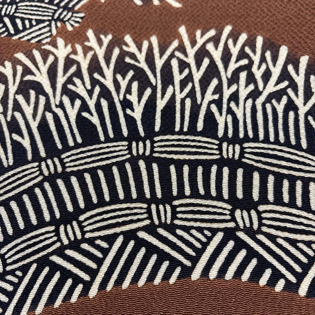 開き名古屋帯【栗山吉三郎】和染紅型 縮緬 垣根文様 茶色 お太鼓柄 正絹 九寸帯