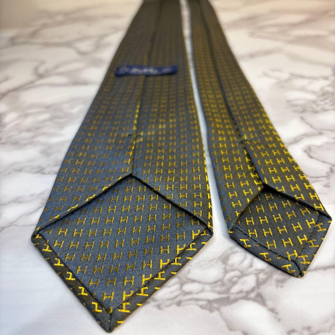 HERMES ネクタイ　イエロー　ネイビー　黄色　紺色　ファソネ　H柄　総柄　艶
