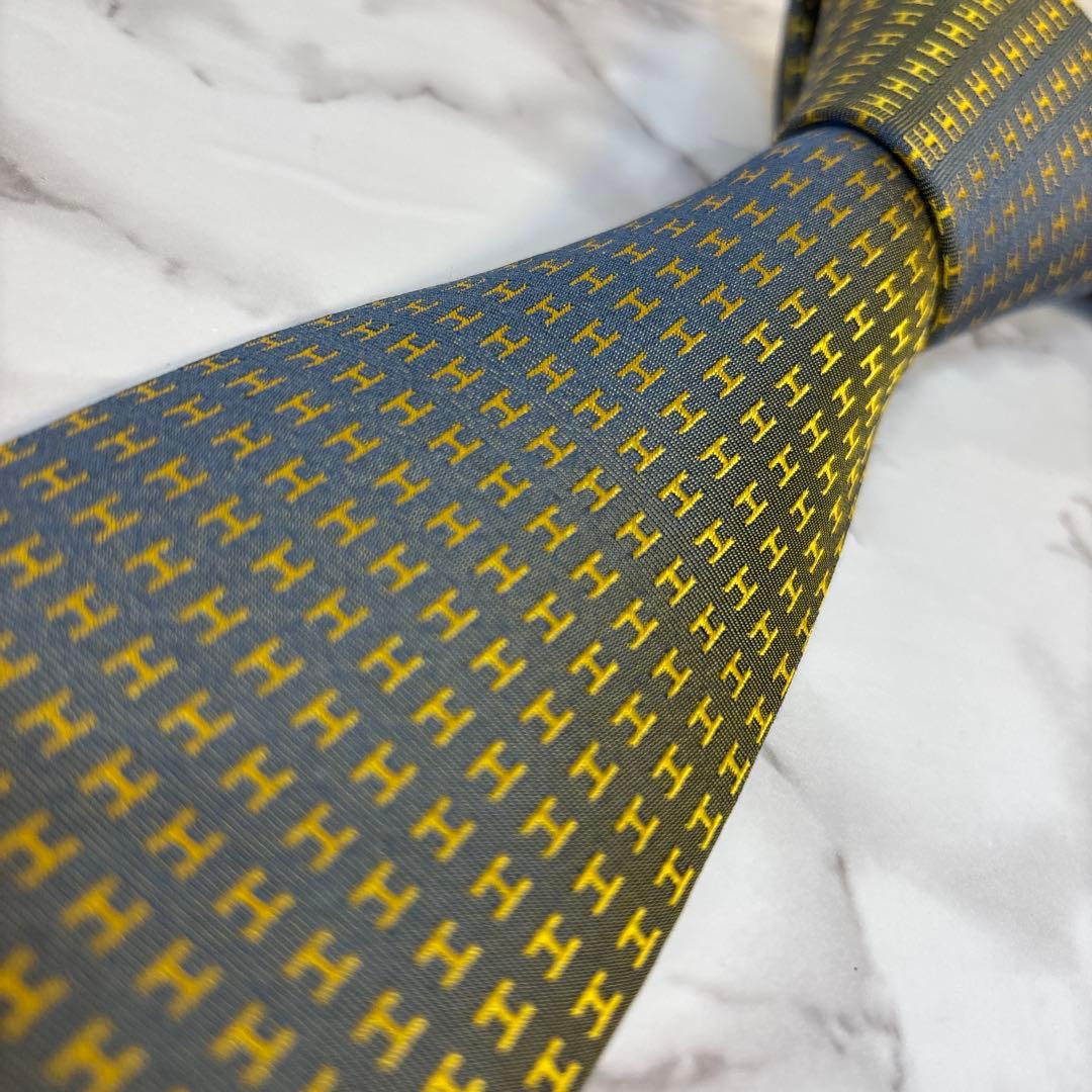 HERMES ネクタイ　イエロー　ネイビー　黄色　紺色　ファソネ　H柄　総柄　艶